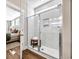 The bathroom features a glass-enclosed shower, tiled walls, and open shelves at 393 Sun Colony Blvd., Longs, SC 29568