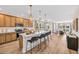 Open concept kitchen featuring an island with seating, modern lighting, and seamless flow to living area at 393 Sun Colony Blvd., Longs, SC 29568