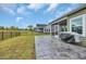 Backyard view of a house with a covered patio, a lawn, and a black metal fence at 4105 Da Vinci Dr., Myrtle Beach, SC 29579