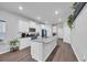 Bright kitchen features an island with granite countertops, white cabinets, and stainless steel appliances at 4105 Da Vinci Dr., Myrtle Beach, SC 29579