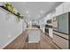Open-concept kitchen and living space featuring an island, stainless steel appliances, and wood-look flooring at 4105 Da Vinci Dr., Myrtle Beach, SC 29579