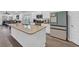 The kitchen features an island with granite countertops, stainless steel appliances, and modern white cabinetry at 4105 Da Vinci Dr., Myrtle Beach, SC 29579