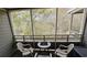 Relaxing screened-in balcony featuring seating, perfect for enjoying the wooded view at 415 Ocean Creek Dr. # 2443, Myrtle Beach, SC 29572