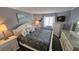 Comfortable bedroom with coordinated furnishings, soft lighting and beach themed art at 415 Ocean Creek Dr. # 2443, Myrtle Beach, SC 29572