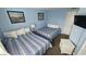 Well-lit bedroom featuring two beds, coordinating decor and ample lighting at 415 Ocean Creek Dr. # 2443, Myrtle Beach, SC 29572