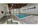 Bright indoor pool with stone flooring and a charming American flag, perfect for year-round enjoyment at 415 Ocean Creek Dr. # 2443, Myrtle Beach, SC 29572