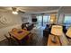 Living room featuring wood floors, ceiling fan, dining area, and sliders to balcony at 415 Ocean Creek Dr. # 2443, Myrtle Beach, SC 29572