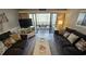 Cozy living room with comfortable seating and balcony access showcasing natural light and views at 415 Ocean Creek Dr. # 2443, Myrtle Beach, SC 29572