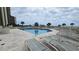 Relax by the sparkling pool with comfortable lounge chairs and palm trees, perfect for leisure at 415 Ocean Creek Dr. # 2443, Myrtle Beach, SC 29572