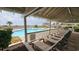 Tranquil poolside view from a shaded area, featuring lounge chairs and a well-maintained pool at 415 Ocean Creek Dr. # 2443, Myrtle Beach, SC 29572