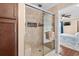 Bathroom showcasing a tiled shower with a glass door and convenient storage at 4387 Landing Rd., Little River, SC 29566