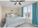 Well-lit bedroom featuring a plush bed, ceiling fan, and a large window with natural light at 4387 Landing Rd., Little River, SC 29566