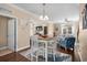 Open dining and living area with dark wood floors, table, and coastal decor at 4387 Landing Rd., Little River, SC 29566