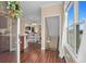 Inviting entryway with hardwood floors leads to a dining area and staircase with natural light shining through at 4387 Landing Rd., Little River, SC 29566