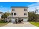 Striking home exterior featuring an expansive driveway, covered pergola, and well-maintained landscaping at 4387 Landing Rd., Little River, SC 29566