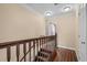 Hallway with dark wood floors and decorative carpeted stairs leading to the upper level at 4387 Landing Rd., Little River, SC 29566