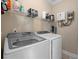 Functional laundry room featuring a Samsung washer and dryer set and a storage shelf at 4387 Landing Rd., Little River, SC 29566