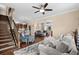 Bright, open-concept living area with hardwood floors and a staircase, leading to the kitchen and dining area at 4387 Landing Rd., Little River, SC 29566