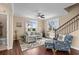 Bright living room with natural light, hardwood floors, comfortable seating, and staircase access at 4387 Landing Rd., Little River, SC 29566