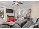 Open-concept living area with hardwood floors, comfortable seating, and a staircase leading to the upper level at 4387 Landing Rd., Little River, SC 29566