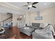 Spacious living room with hardwood floors, stylish sectional, and seamless transition to dining and kitchen areas at 4387 Landing Rd., Little River, SC 29566
