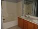 Bathroom with double sinks, tile floors, and shower-tub combo at 4664 Southgate Pkwy., Myrtle Beach, SC 29579