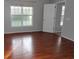 Cozy bedroom featuring hardwood floors, a large window, and a closet at 4664 Southgate Pkwy., Myrtle Beach, SC 29579