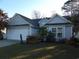 Charming single-story home with manicured lawn, mature trees, and a two-car garage at 4664 Southgate Pkwy., Myrtle Beach, SC 29579