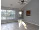 Bright living room featuring a ceiling fan, tile flooring, and large windows at 4664 Southgate Pkwy., Myrtle Beach, SC 29579