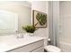 Well-lit bathroom featuring a sink, toilet, tub, and decorative plant creating a clean and inviting space at 474 Blissful Ln., Little River, SC 29566