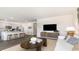 Open-concept living room features a stylish kitchen with stainless steel appliances and a comfortable seating area at 474 Blissful Ln., Little River, SC 29566
