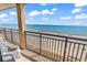 Balcony overlooking the ocean with chairs at 4800 S Ocean Blvd. # 1103, North Myrtle Beach, SC 29582
