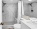 Bright bathroom with a white vanity, modern fixtures, and shower with marble-like tiling and pebble floor at 4800 S Ocean Blvd. # 1103, North Myrtle Beach, SC 29582
