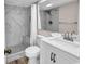 Bathroom featuring marble tiled shower, a white sink vanity, and a soft stone pebble floor at 4800 S Ocean Blvd. # 1103, North Myrtle Beach, SC 29582