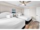 Bright bedroom featuring two queen beds with white linens, a ceiling fan, and closet at 4800 S Ocean Blvd. # 1103, North Myrtle Beach, SC 29582