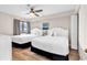 Bright bedroom featuring two queen beds with white linens, a ceiling fan, and wood-look floors at 4800 S Ocean Blvd. # 1103, North Myrtle Beach, SC 29582