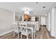 Comfortable dining area adjacent to the kitchen featuring white dining set and hardwood floors at 4800 S Ocean Blvd. # 1103, North Myrtle Beach, SC 29582