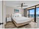 Bright main bedroom boasts a white bed set and balcony access with an ocean view at 4800 S Ocean Blvd. # 1103, North Myrtle Beach, SC 29582