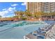 Beautiful pool area with palm trees and plenty of lounge chairs for relaxing in the sun at 4800 S Ocean Blvd. # 1103, North Myrtle Beach, SC 29582