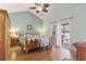 Bright bedroom with hardwood floors, ceiling fan, and sliding door access to a private balcony at 5012 Prato Loop # 5012, Myrtle Beach, SC 29579