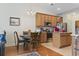 Cozy kitchen area featuring wood cabinets, stainless steel appliances, island and a dining table at 5012 Prato Loop # 5012, Myrtle Beach, SC 29579