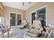 Screened-in patio featuring cozy seating, offering a relaxing outdoor living space with serene ambiance at 5012 Prato Loop # 5012, Myrtle Beach, SC 29579