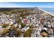 Aerial view of a residential area with houses, trees, and a pond near the beach at 6001 - 1125 S Kings Hwy., Myrtle Beach, SC 29575