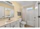 Well-lit bathroom featuring a toilet, shower, and vanity with mirror and drawers at 6001 - 1125 S Kings Hwy., Myrtle Beach, SC 29575