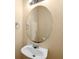 Bathroom featuring a pedestal sink, round mirror, and modern faucet at 6001 - 1125 S Kings Hwy., Myrtle Beach, SC 29575