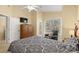 Bright bedroom featuring a comfortable chair, a door to the outside and a large bed at 6001 - 1125 S Kings Hwy., Myrtle Beach, SC 29575