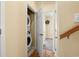 Laundry area near a hallway and a room with a mounted television at 6001 - 1125 S Kings Hwy., Myrtle Beach, SC 29575