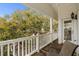 Charming porch with railing, featuring a chair and lovely outdoor views framed by a large tree at 6001 - 1125 S Kings Hwy., Myrtle Beach, SC 29575