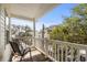 Relaxing porch with chairs, offering a view of the neighborhood trees and a blue sky at 6001 - 1125 S Kings Hwy., Myrtle Beach, SC 29575