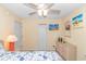 Cozy bedroom with a wall-mounted TV, ceiling fan and wicker dresser at 6001- 310 S Kings Hwy., Myrtle Beach, SC 29575